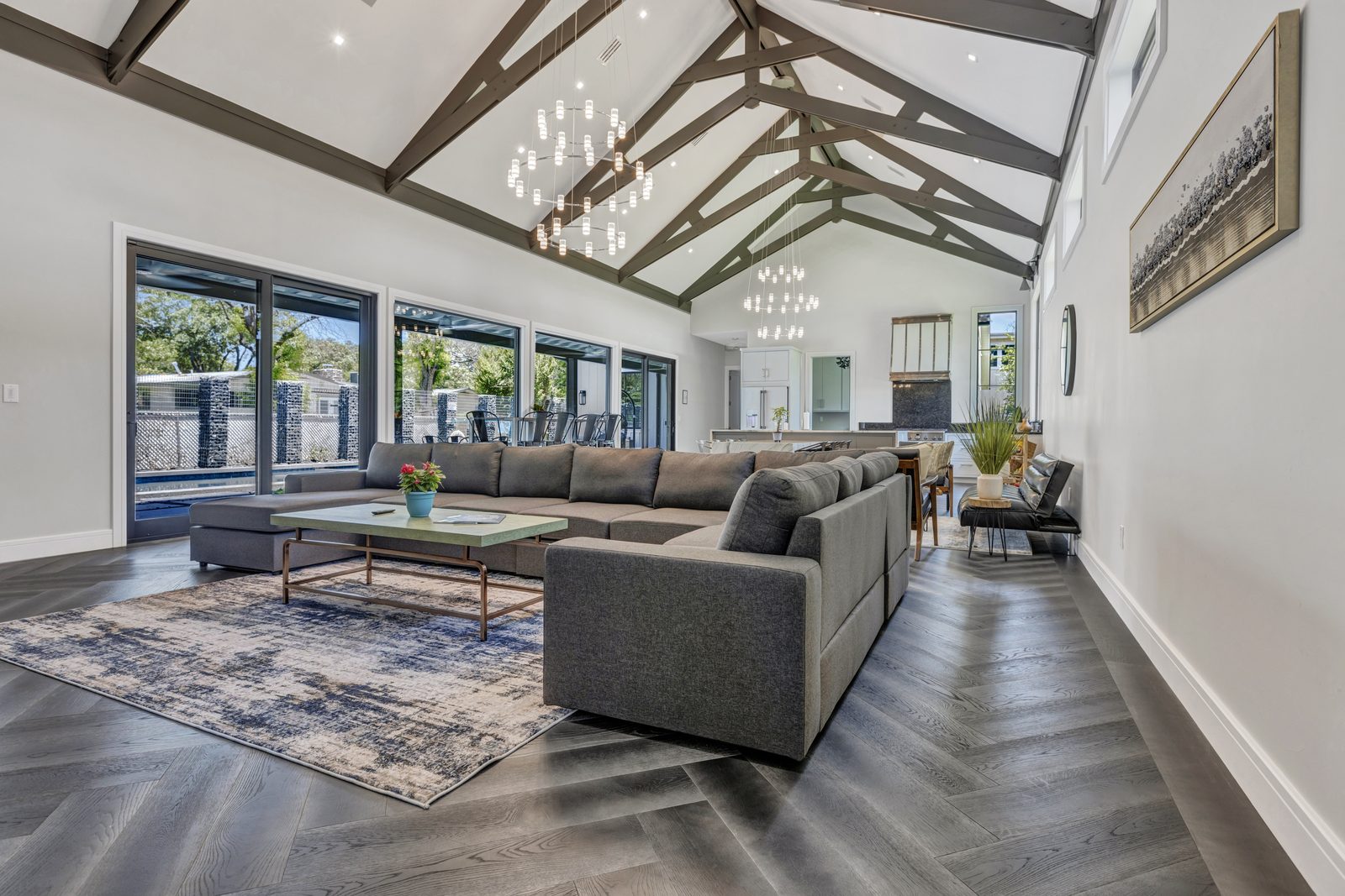 Great room with vaulted ceilings and chandeliers at Giving Tree