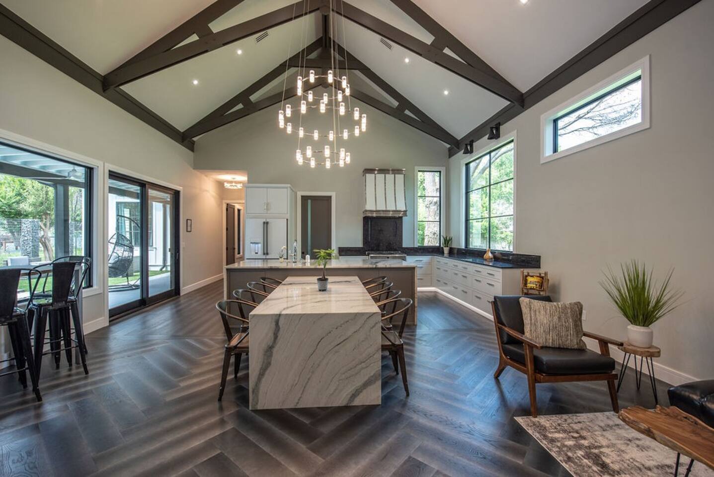 Great room with elegant chandeliers and natural light